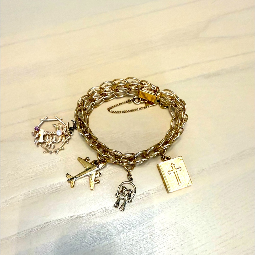 Vintage gold Monet charm bracelet with 4 charms.